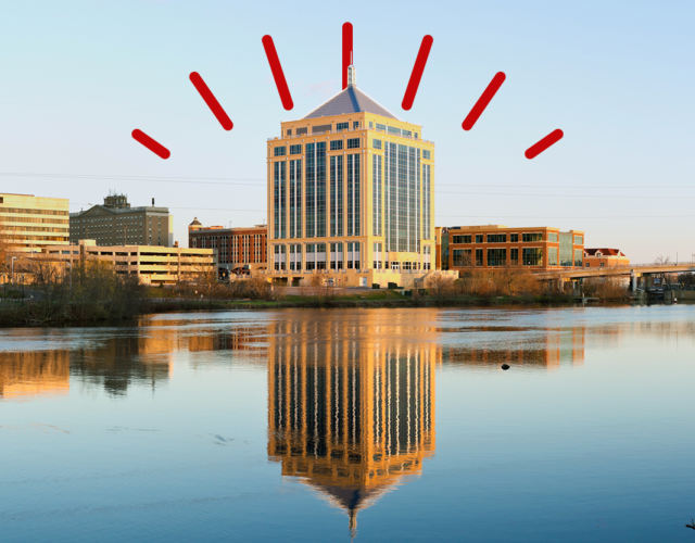 City of Wausau skyline reflected over body of water.