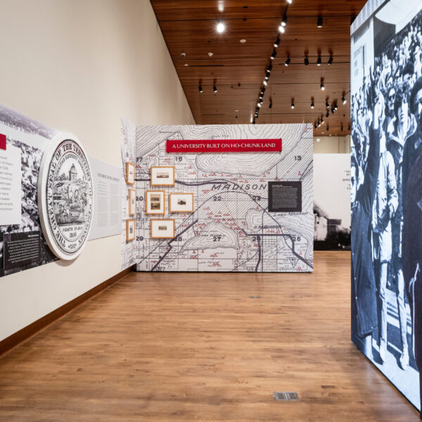 Artifacts and wall panels on display at “Sifting and Reckoning: UW–Madison’s History of Exclusion and Resistance” exhibit.