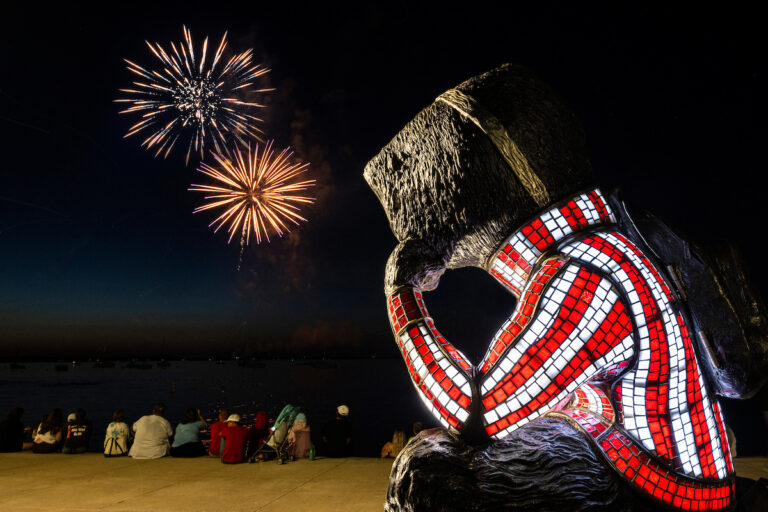 Fireworks over Lake Mendota with Bucky in foreground.