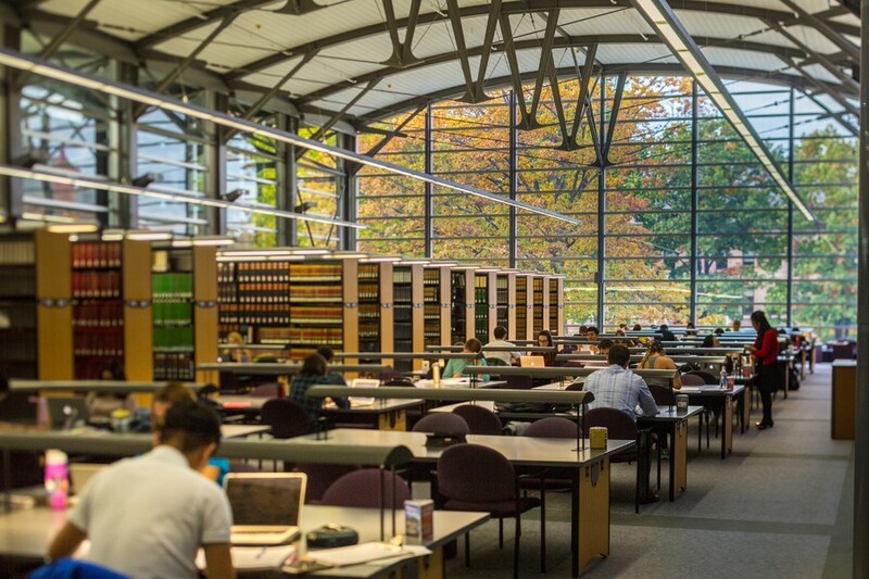 A photo of the UW Law School library atrium with students sat at desks.