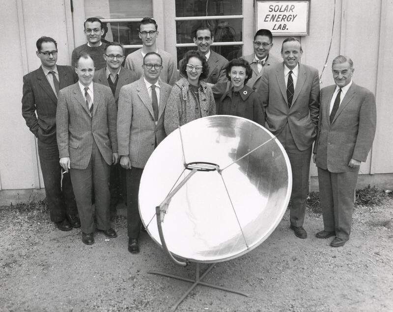 A group photo of people associated with UW's Solar Energy Lab (ca. 1955-1965) standing around a solar collector
