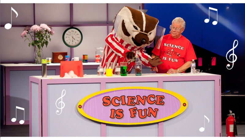A photo of Dr. Shakhashiri and Bucky Badger, doing a science experiment, with music notes floating around.