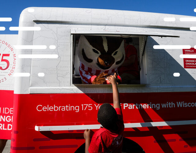 Bucky Badger serving ice cream through 175th anniversary truck window to child.