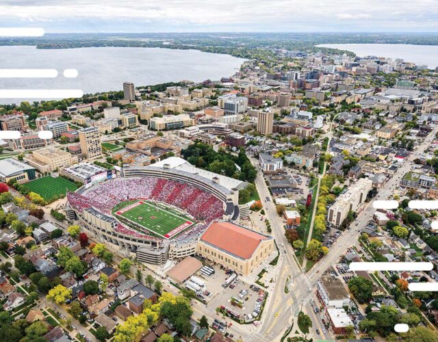 Aerial view of UW–Madison campus and downtown Madison Isthmus with Camp Randall Stadium in foreground.