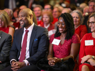 175 Gala - Charles and Sheila Isbell and Sarah Schutt Close up of people seated smiling and laughing during presentation.