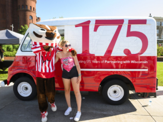 175 Launch – Ice Cream Truck Person posing with Bucky Badger in front of red and white truck decorated for the 175th anniversary.