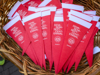 175 Launch – Demisemiseptcentennial Flags Pile of red and white Demisemiseptcentennial flags in woven basket.