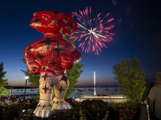 175 Launch – Fireworks and Bucky on Parade Statue Bucky Badger statue in foreground with fireworks booming over lake during summer evening in background.