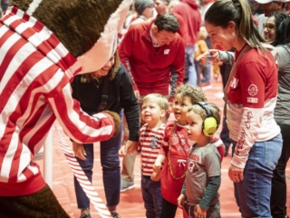 175 Open House - Family Fun Fair Bucky Bucky Badger meeting group of smiling young children and family members.