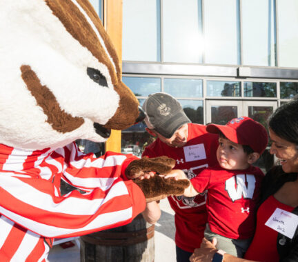 Bucky Badger meets a young child.